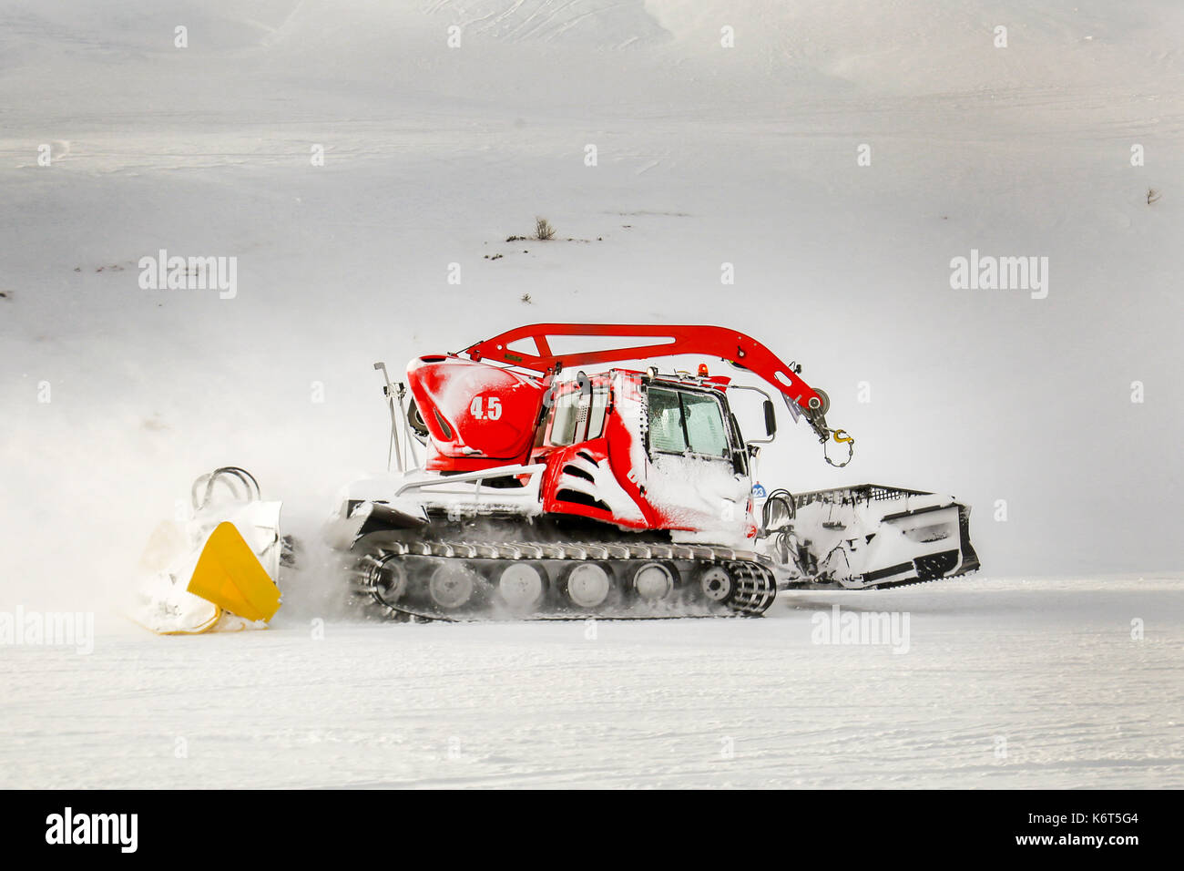 Ratrack,a snow grooming machine preparing slopes for skiers on a ski resort in mountains Stock Photo