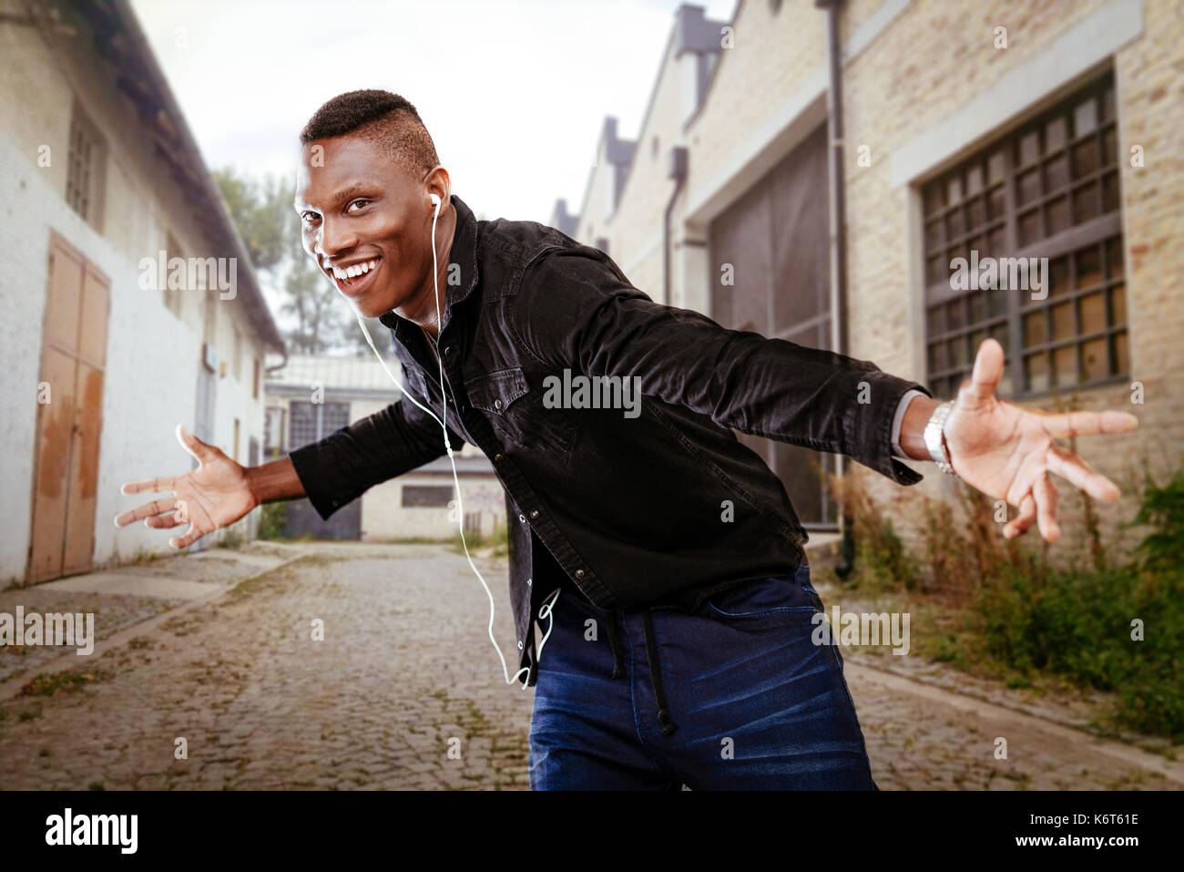 African guy wearing headphones and dancing Stock Photo Alamy