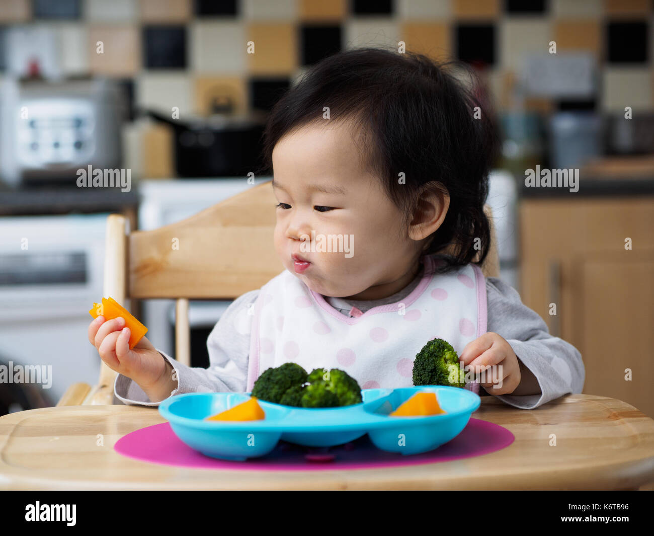 baby eating vegetable at home Stock Photo - Alamy
