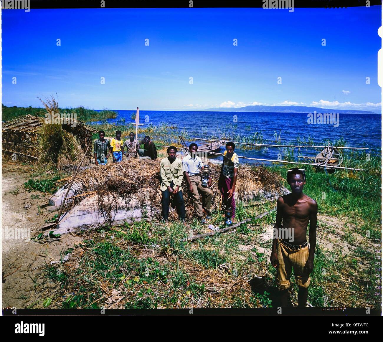 Burundi, Rumonge Province, group of fishermen on Lake Tanganyika, fishermen are exclusively Hutu and come down from the hills to settle in temporary huts for at least 6 months, fishing is generally done at night with lampara and it's mainly ndagalas (fried fish) mukekes and Lates niloticus (4x5 reversal film reproduction) Stock Photo