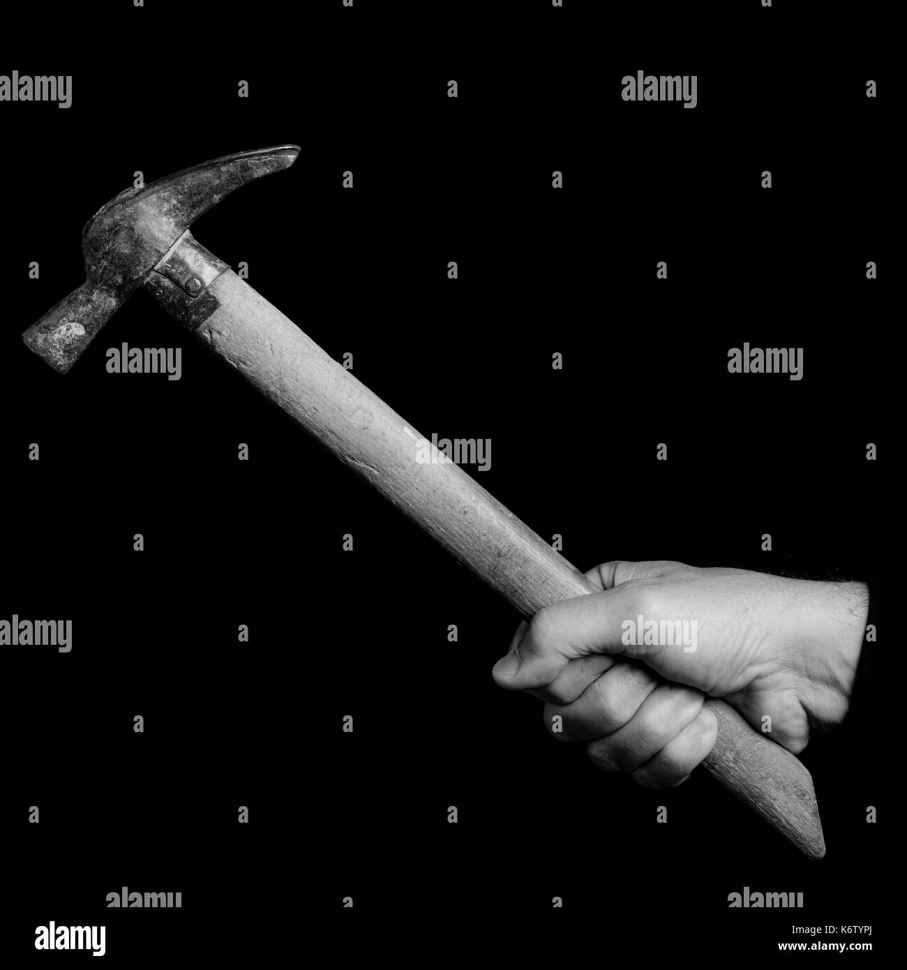 bricklayer  hammer- tools in a man's hand - black and white photo Stock Photo