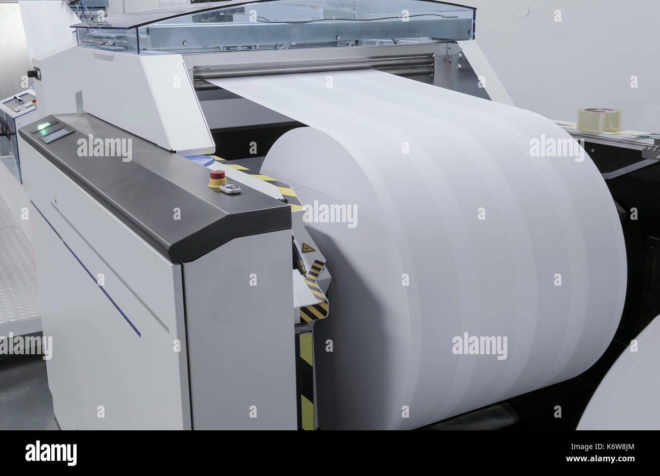 Printer working with large newsprint roll in printing machine Stock