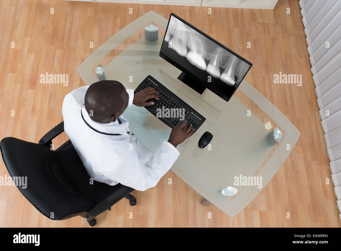 Young African Dentist Analyzing X-ray Teeth On Screen Of Computer At ...