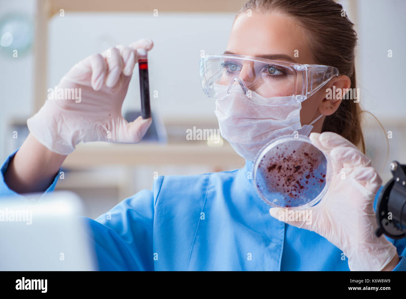 Female scientist researcher conducting an experiment in a laboratory ...