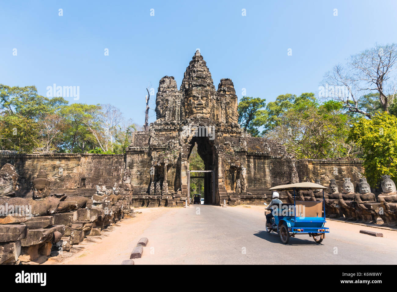 Tuk tuk and angkor thom gate in siem reap cambodia Stock Photo