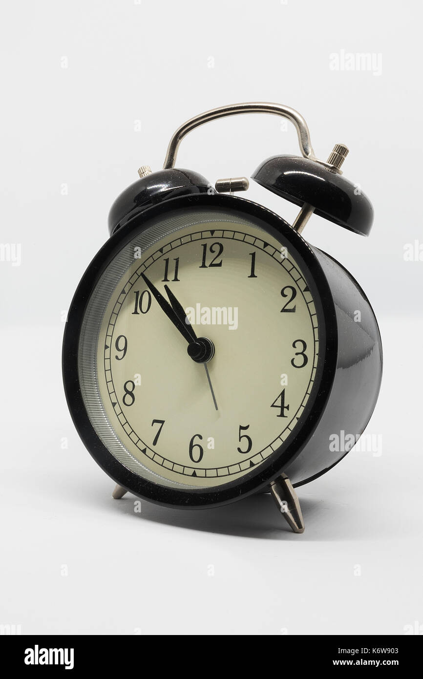 analog black alarm clock isolated on white background Stock Photo - Alamy