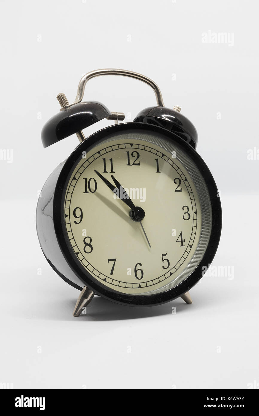 analog black alarm clock isolated on white background Stock Photo - Alamy