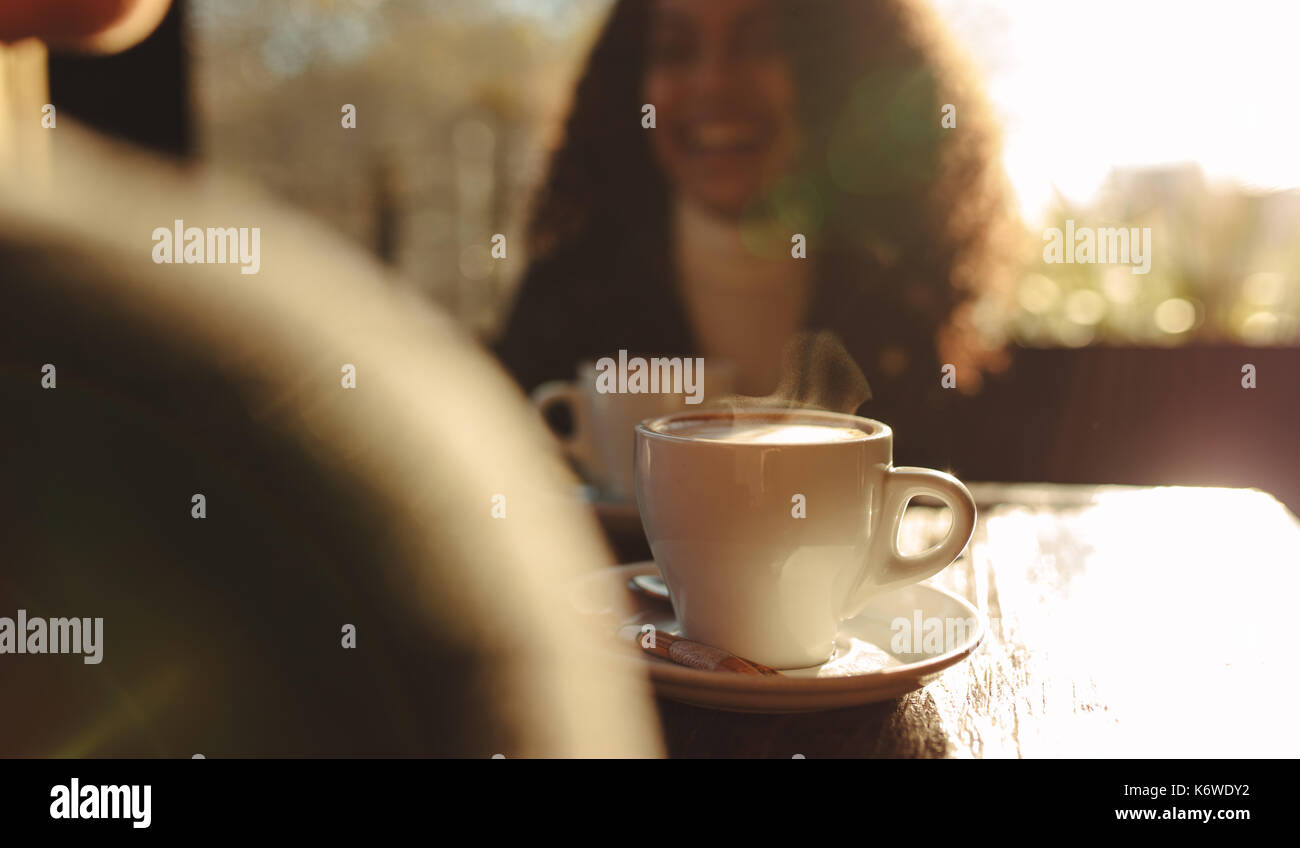 https://c8.alamy.com/comp/K6WDY2/close-up-shot-of-steaming-hot-coffee-cup-on-a-table-with-blurred-view-K6WDY2.jpg