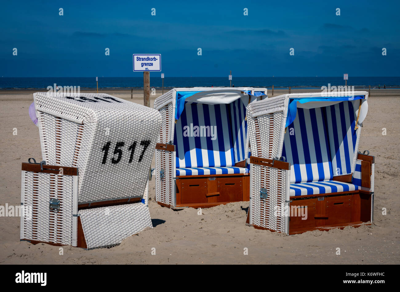Beach chairs with sign Strandkorbgrenze, beach, Sankt Peter Ording, North Sea, Schleswig Holstein, Germany Stock Photo