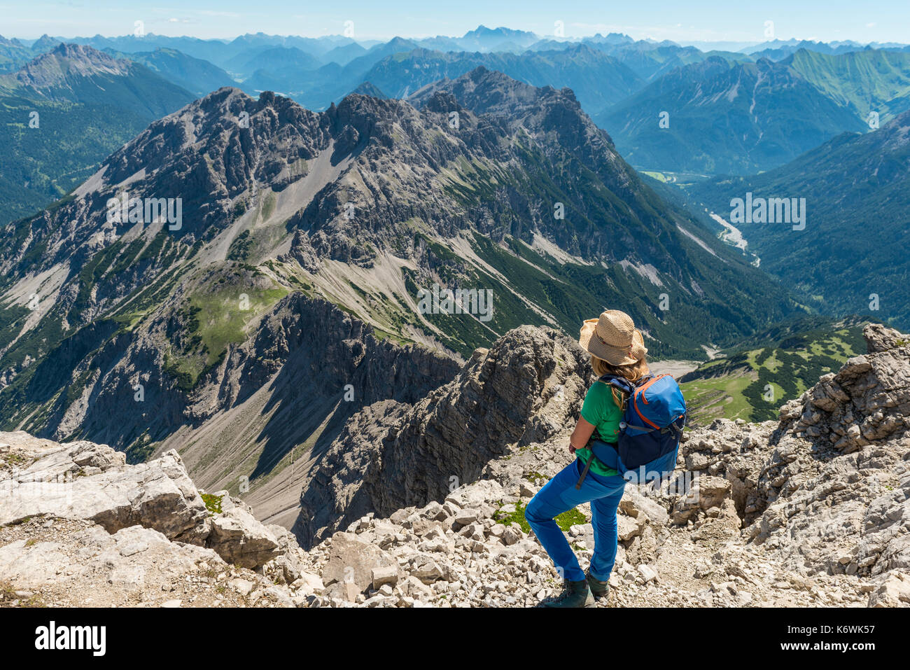 Hiker overlooks mountains and Alps, Hiking trail to the Hochvogel, small Roßzahn, Allgäu, Allgäuer Hochalpen, Bavaria Stock Photo