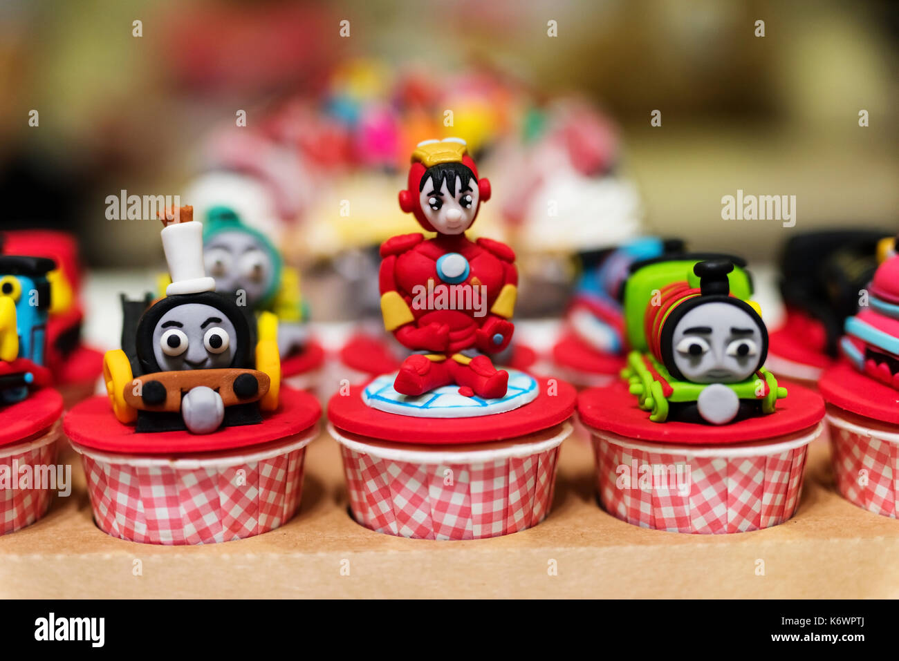 Beautiful handmade cupcake with famous Iron man and Thomas train models for kid birthday celebration Stock Photo