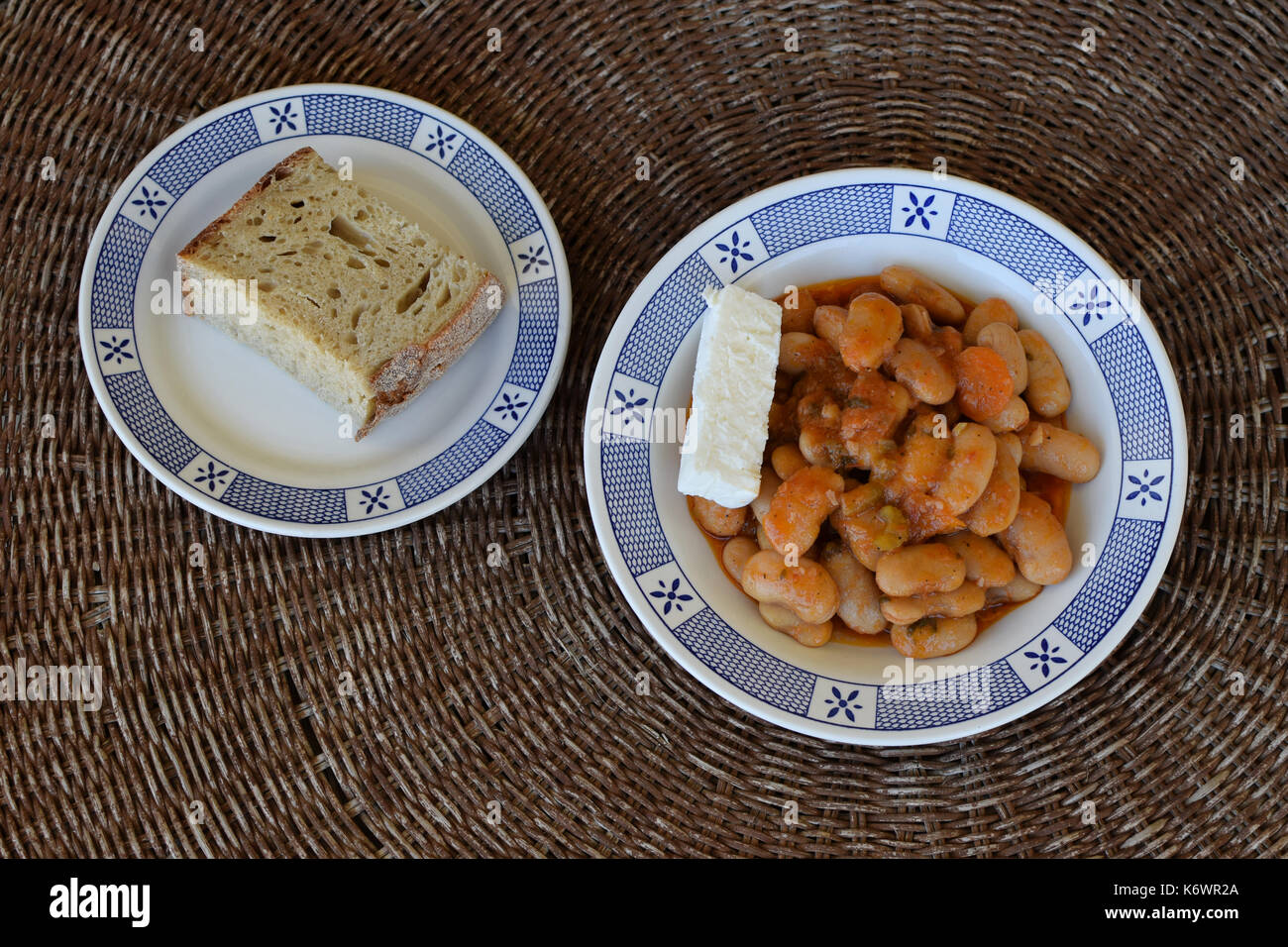 Baked giant beans gigantes with feta cheese and bread. Greek food Stock