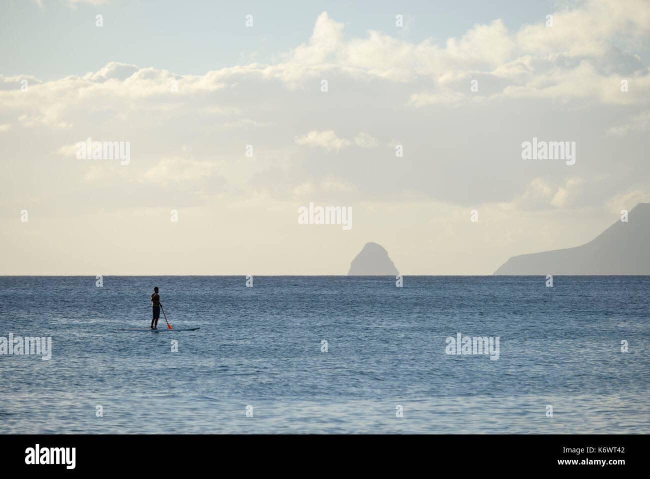 France, Martinique (French West Indies), Sainte Anne, beach of the Salines, view off towards the Diamond, man paddling Stock Photo