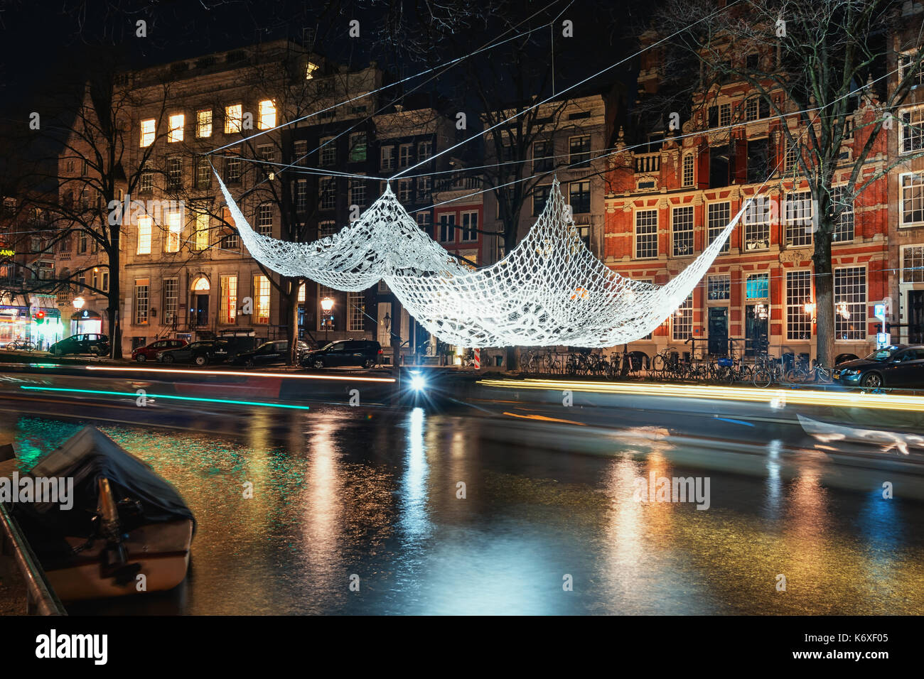 Amsterdam, Netherlands, January 5, 2017: Crochet and illuminated giant bedspread float above a canal during the Festival of Light in Amsterdam Stock Photo