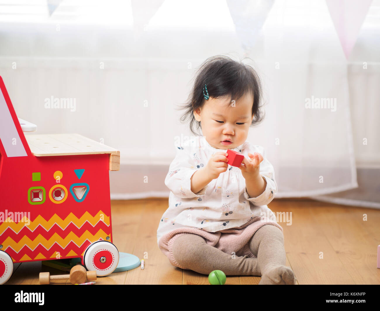 cute baby girl play toy at home Stock Photo - Alamy