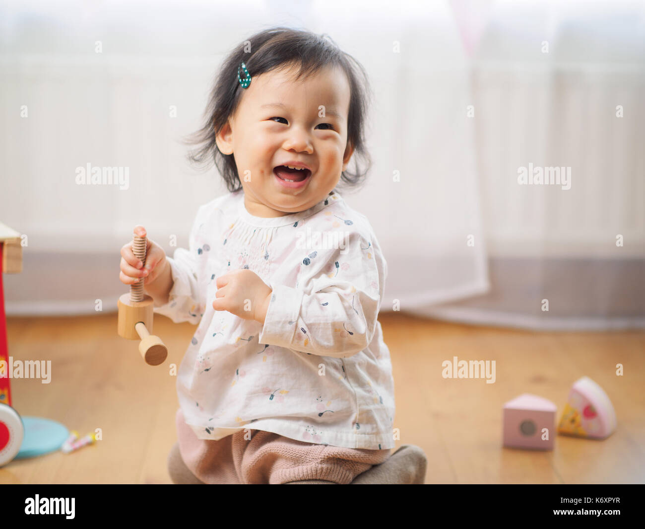 cute baby girl play toy at home Stock Photo - Alamy