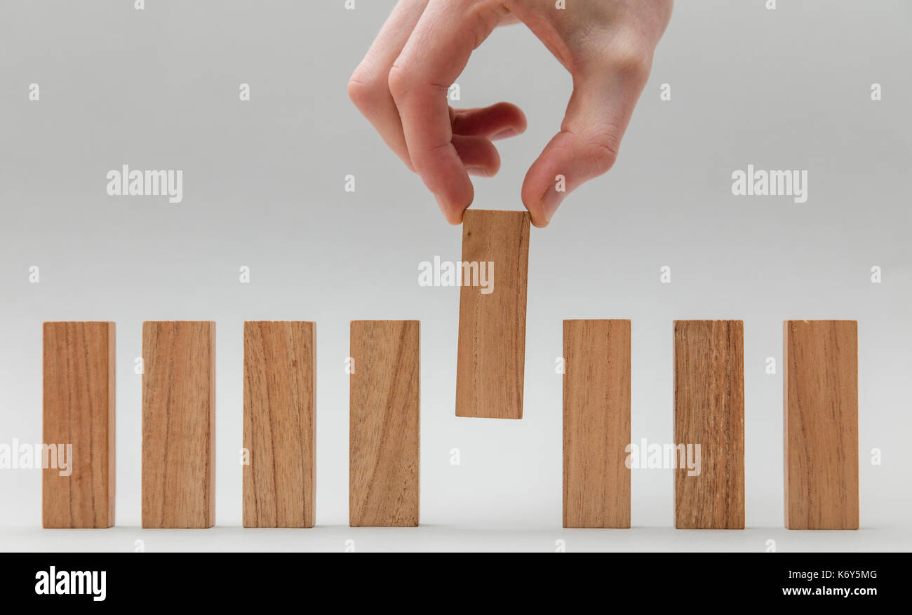 Male hand stacking wooden blocks in a line. Business development and ...