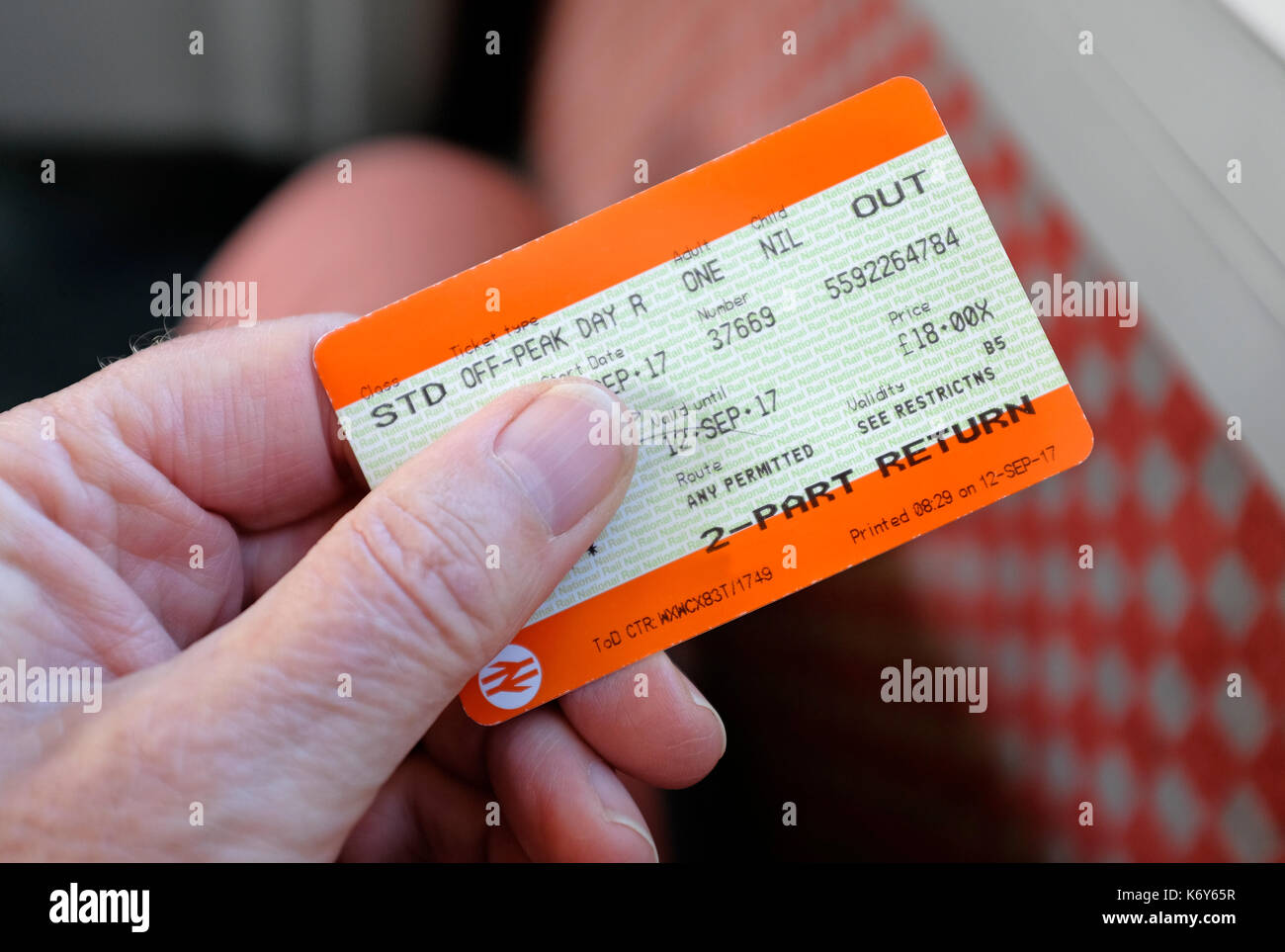 male hand holding rail travel ticket Stock Photo