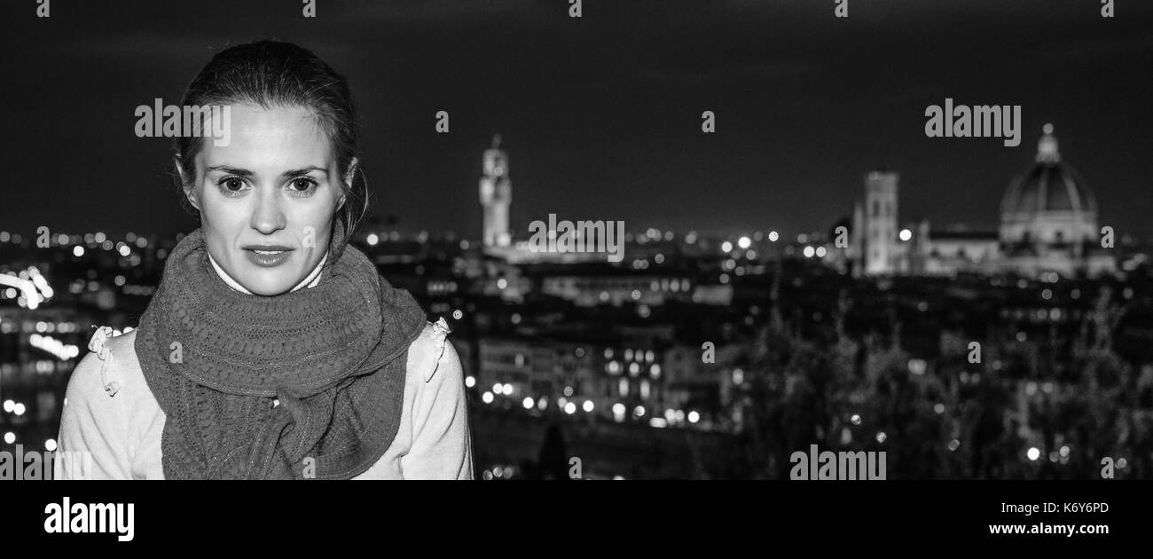 Trip full of inspiration at Christmas time in Florence. Portrait of young woman in Christmas hat at Piazzale Michelangelo in Florence, Italy Stock Photo