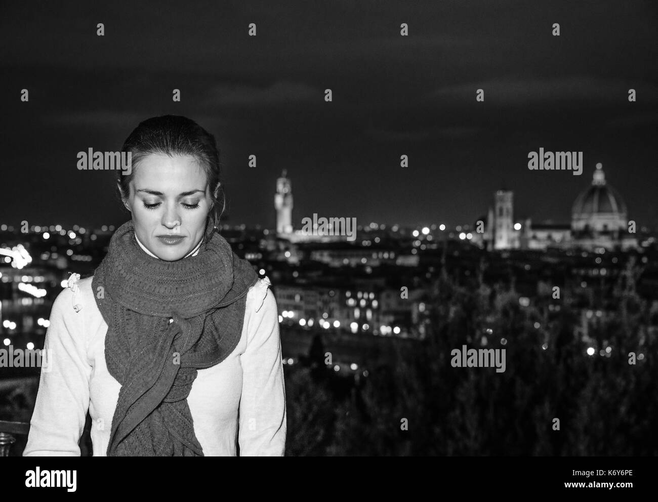 Trip full of inspiration at Christmas time in Florence. Portrait of pensive young woman in Christmas hat in the front of panoramic view of Florence Stock Photo
