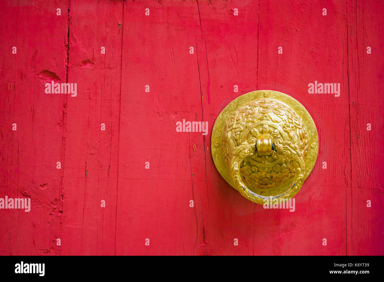 Red wooden door and golden knocker door of chinese temple or palace for background and texture Stock Photo