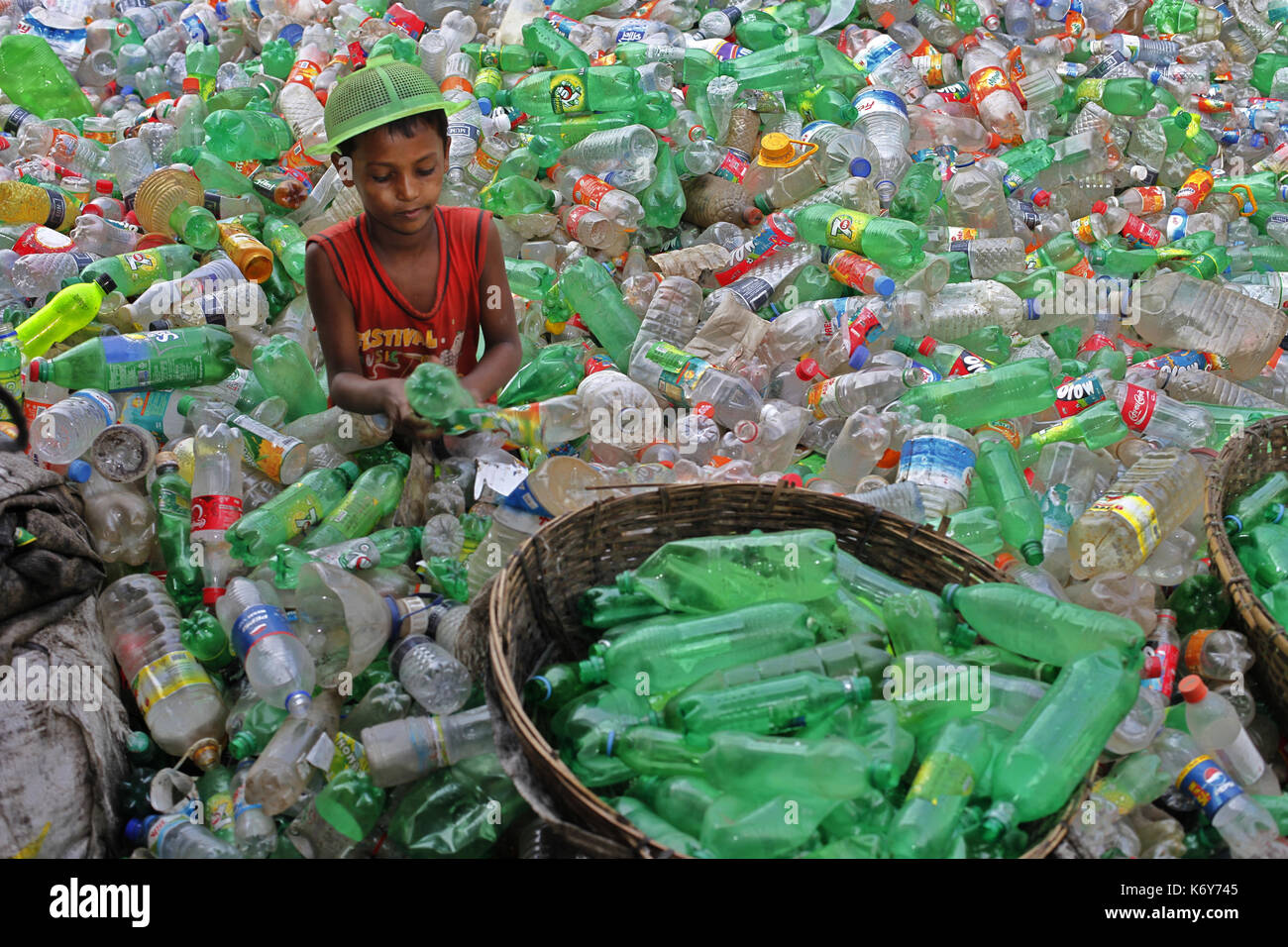 A boy works at a plastic recycling factory in Dhaka, Bangladesh on