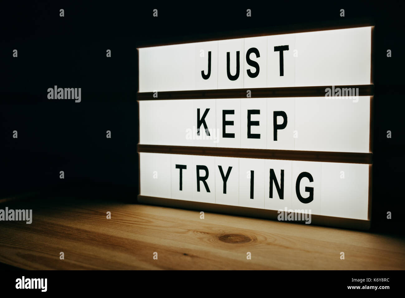 Just keep trying, motivational message on lightbox Stock Photo