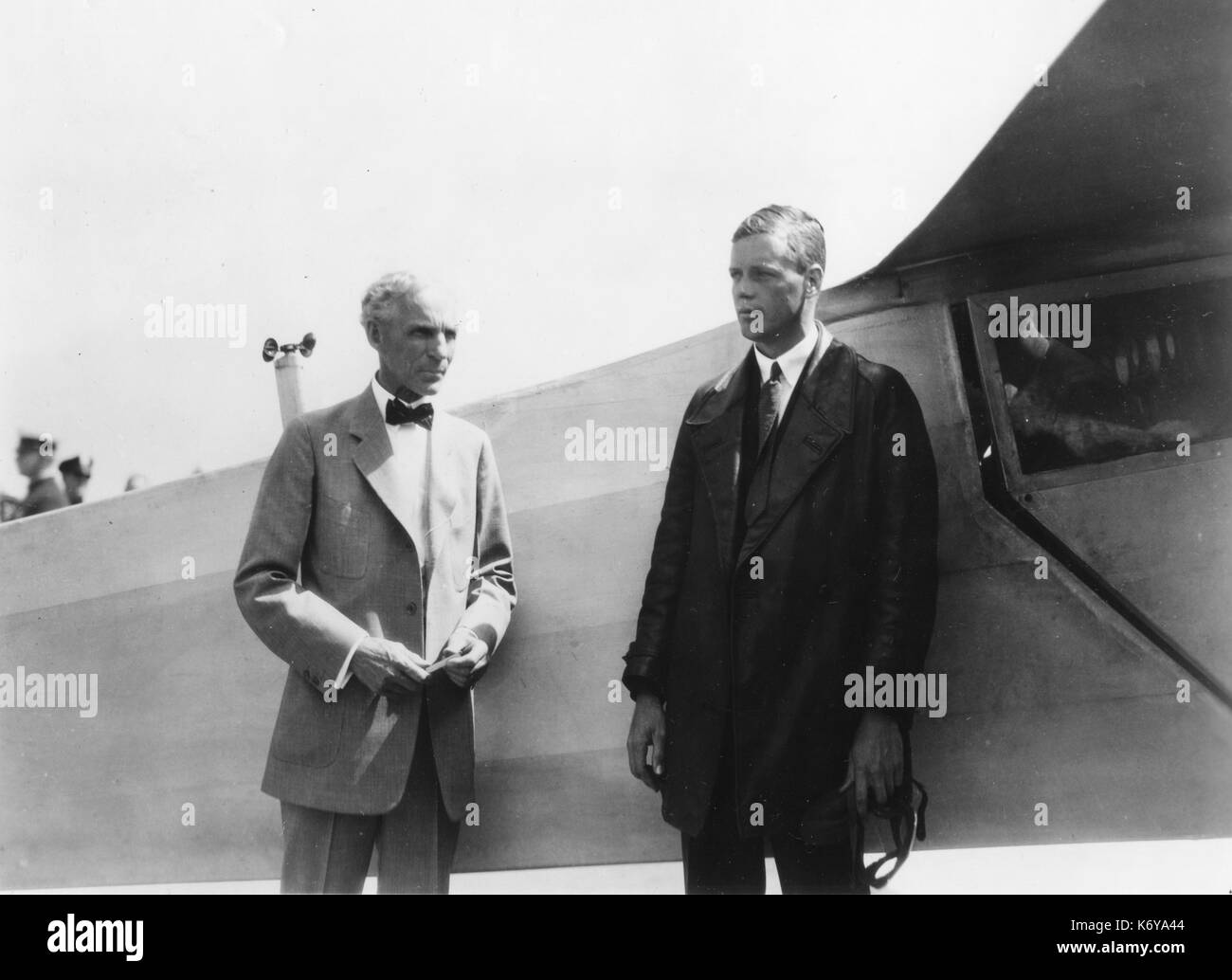 The Lone Eagle, Charles A. Lindbergh (right), stands with Henry Ford beside the 'Spirit of St. Louis,' the plane in which Col Lindbergh flew the first transatlantic solo flight in 1927. The famous flyer visited Mr. Ford in Dearborn in August 1927. Dearborn, MI, 1927. Stock Photo