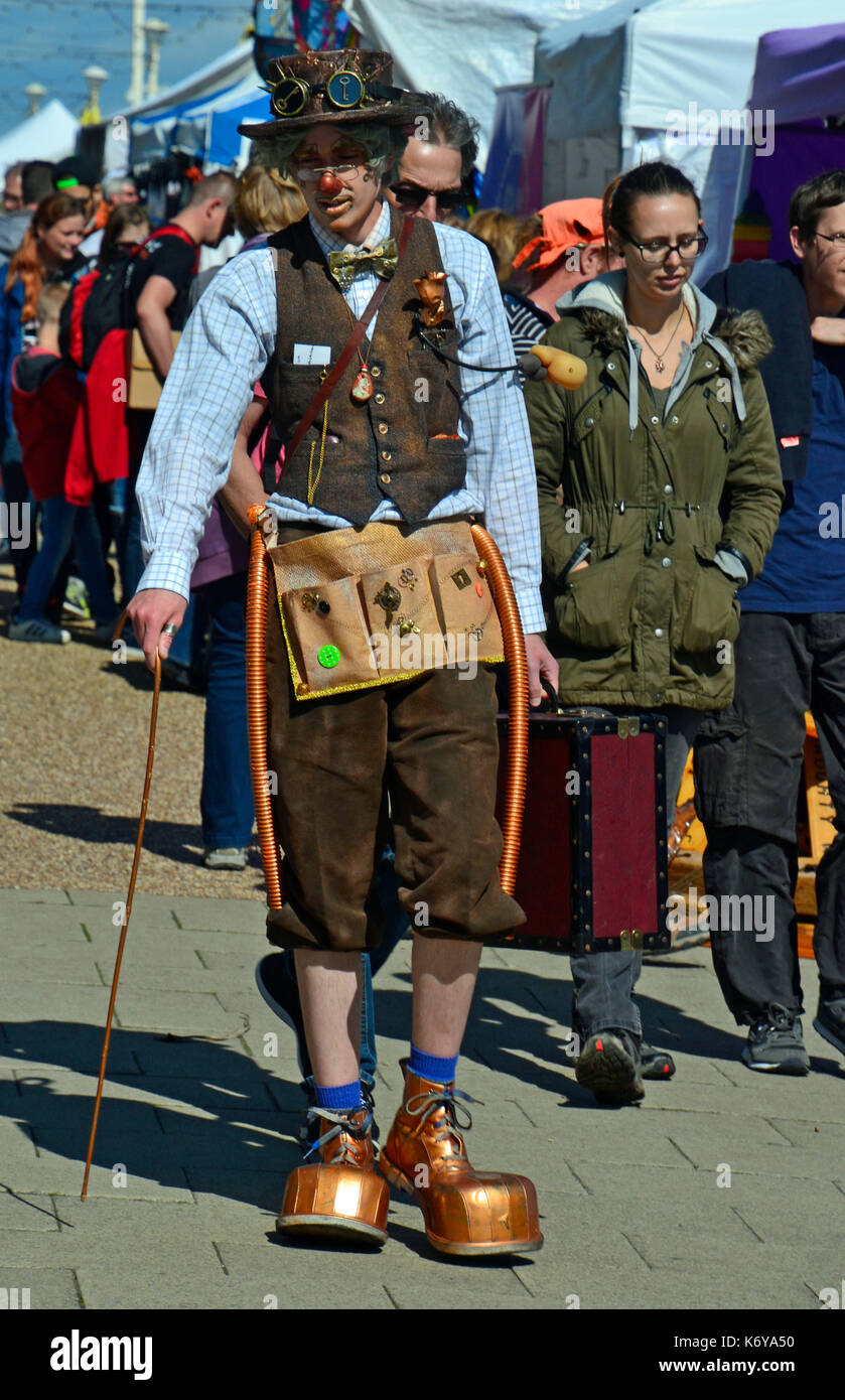 Man at Eastbourne Steampunk Festival with striking gold boots, top hat,  and Victorian inventor themed outfit. Stock Photo