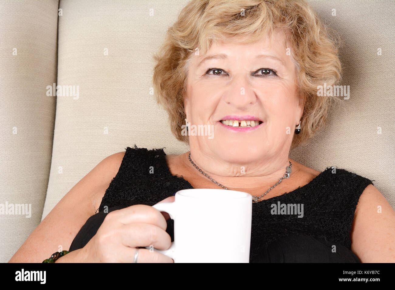 Old woman sitting alone sofa hi-res stock photography and images - Alamy