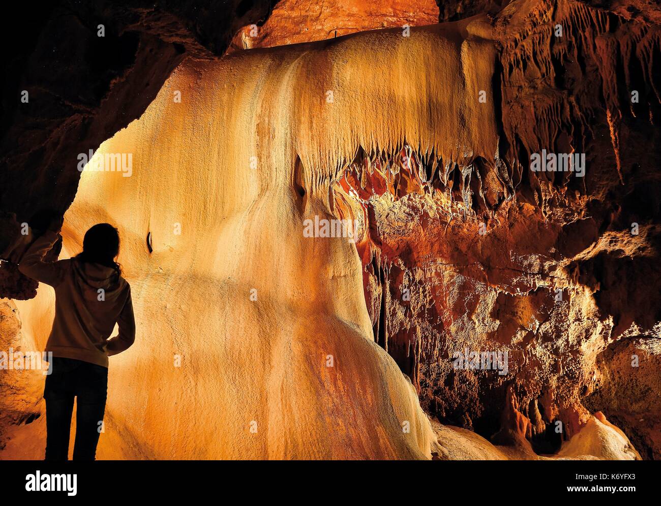 France, Lot, listed at Great Tourist Sites in Midi Pyrenees, Natural regional park Causses du Quercy, Lacave, Lacave cave, visitor before a calcite drapery Stock Photo