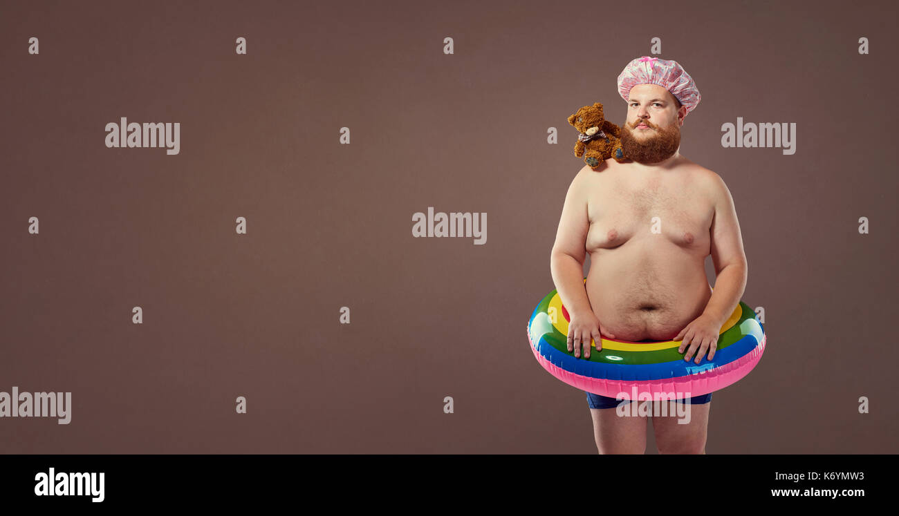 Funny fat bearded man in a swimsuit. Stock Photo
