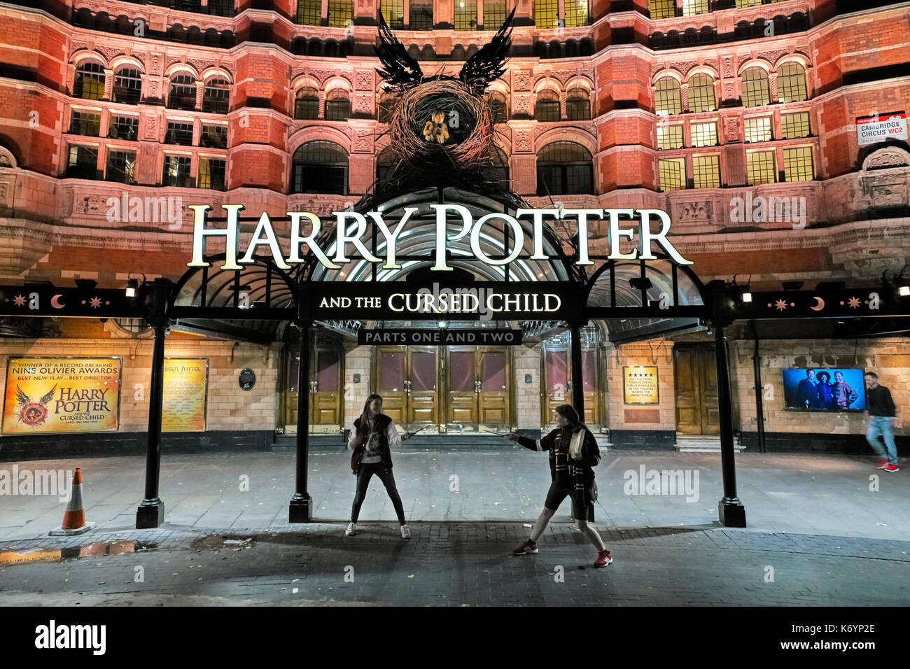 Two teenagers playing Harry Potter outside theatre in London Stock Photo