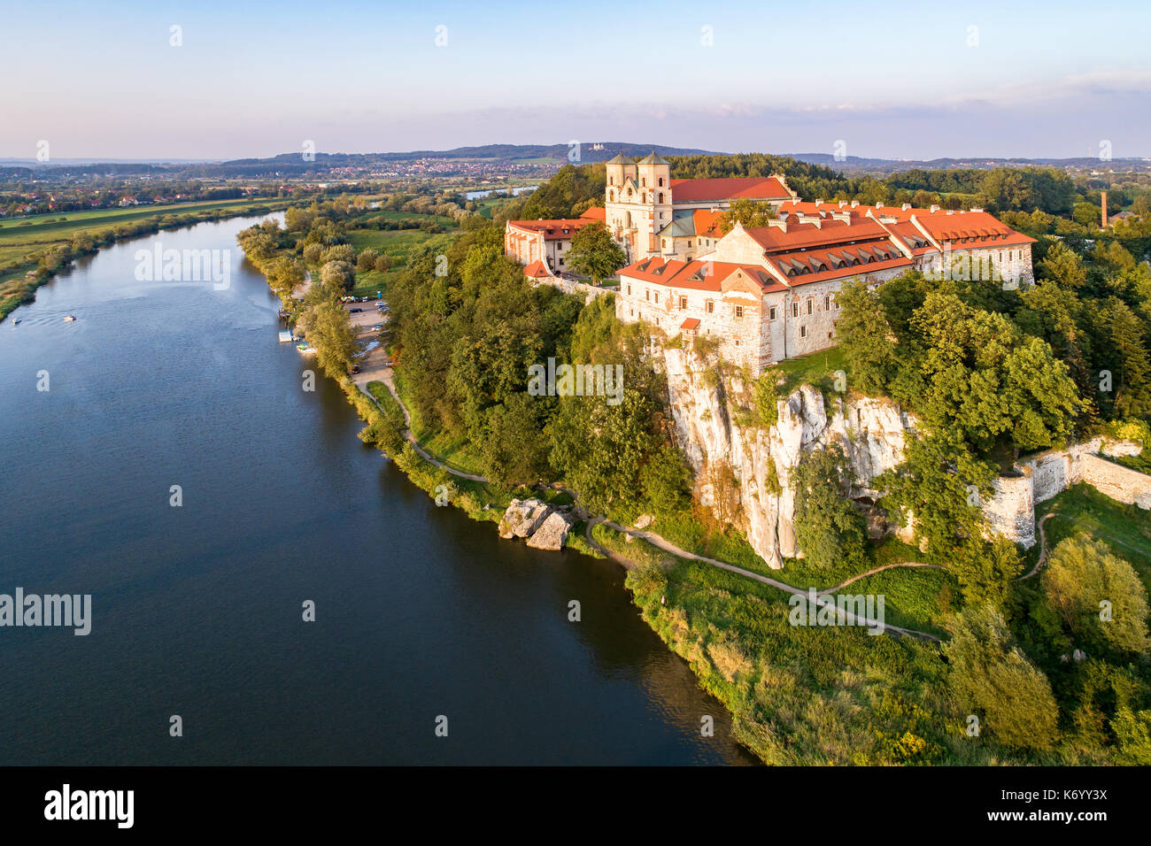 Benedictine monastery on the rocky cliff in Tyniec near Krakow, Poland, and Vistula River. Aerial view at sunset Stock Photo