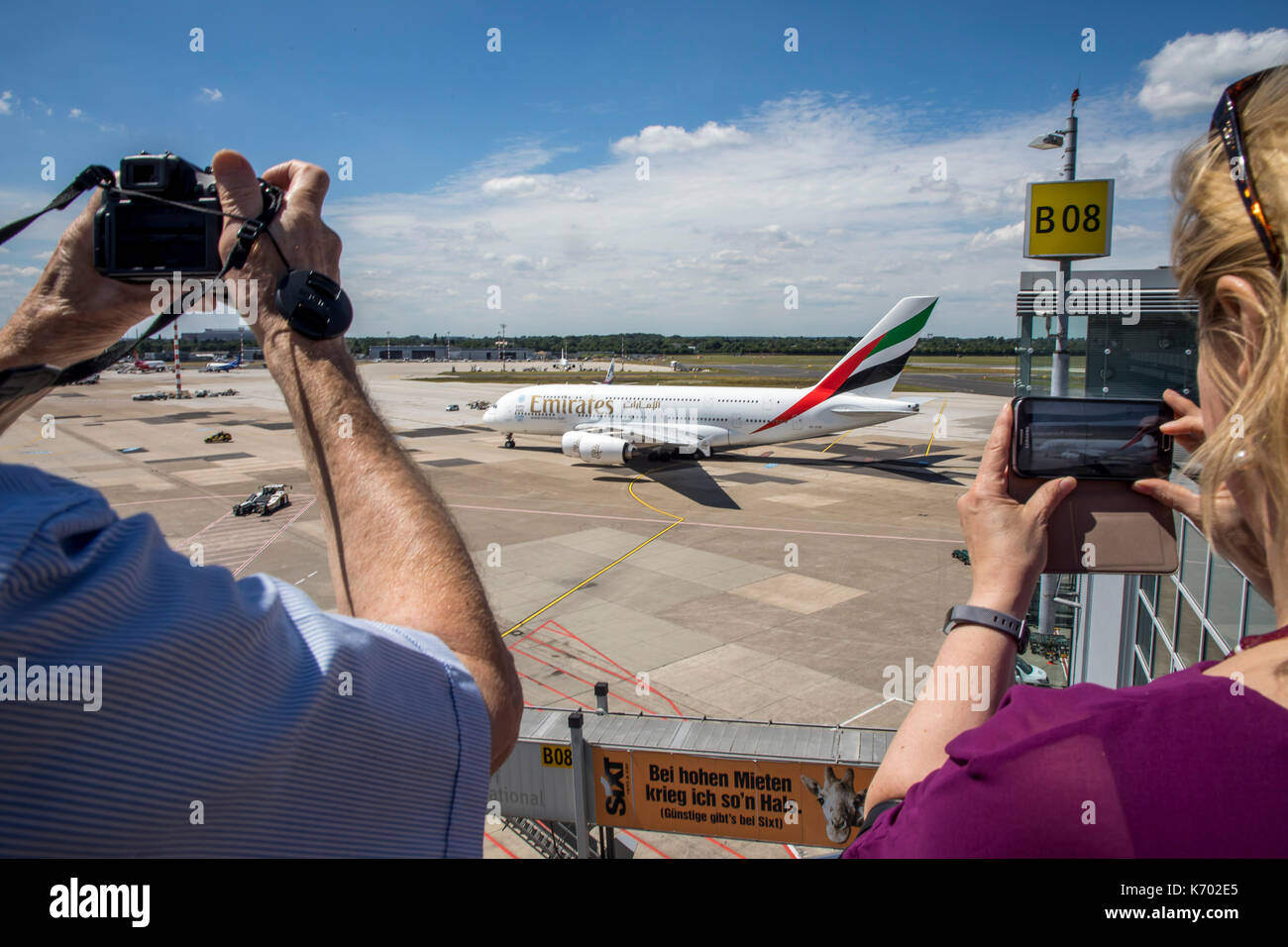 DŸsseldorf International Airport, Germany, Emirates Airbus A380-800 on taxiway, plane spotter on the observation deck, Stock Photo