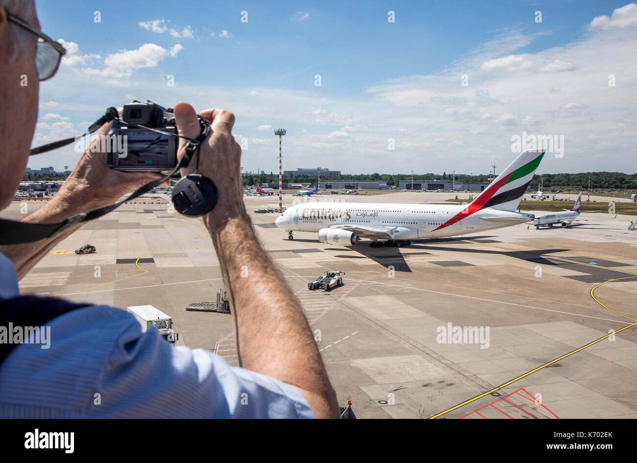 DŸsseldorf International Airport, Germany, Emirates Airbus A380-800 on taxiway, plane spotter on the observation deck, Stock Photo