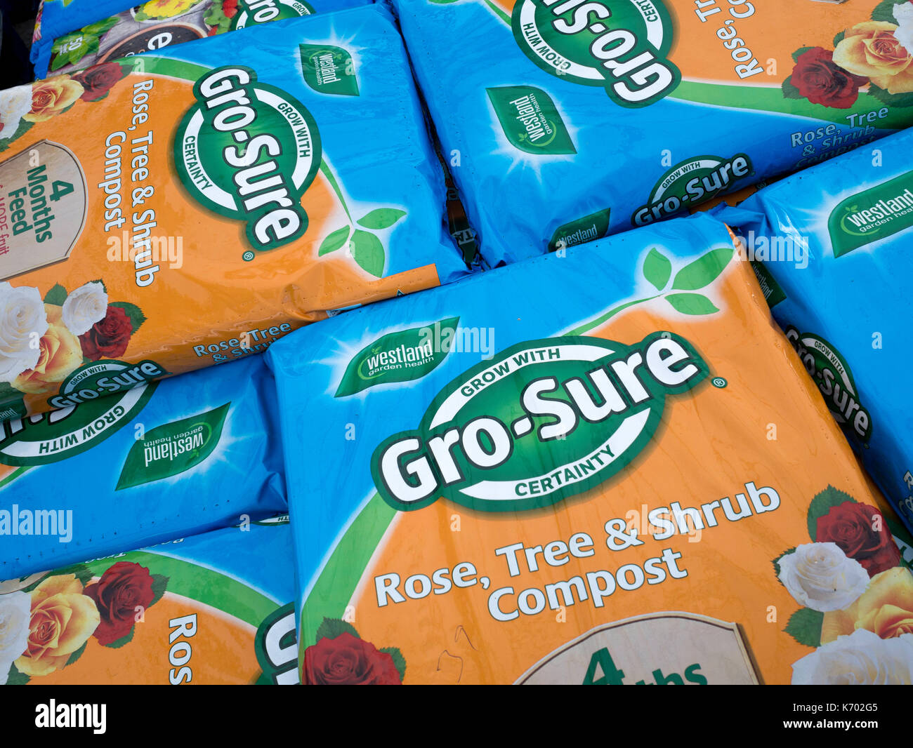 A stack of Grow Sure Rose Tree and Shrub Growing Compost in a garden centre Stock Photo Alamy