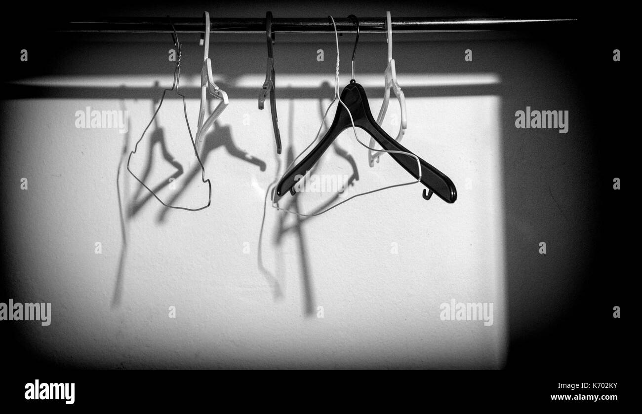 Several hangers hung in a cupboard, conceptual image Stock Photo