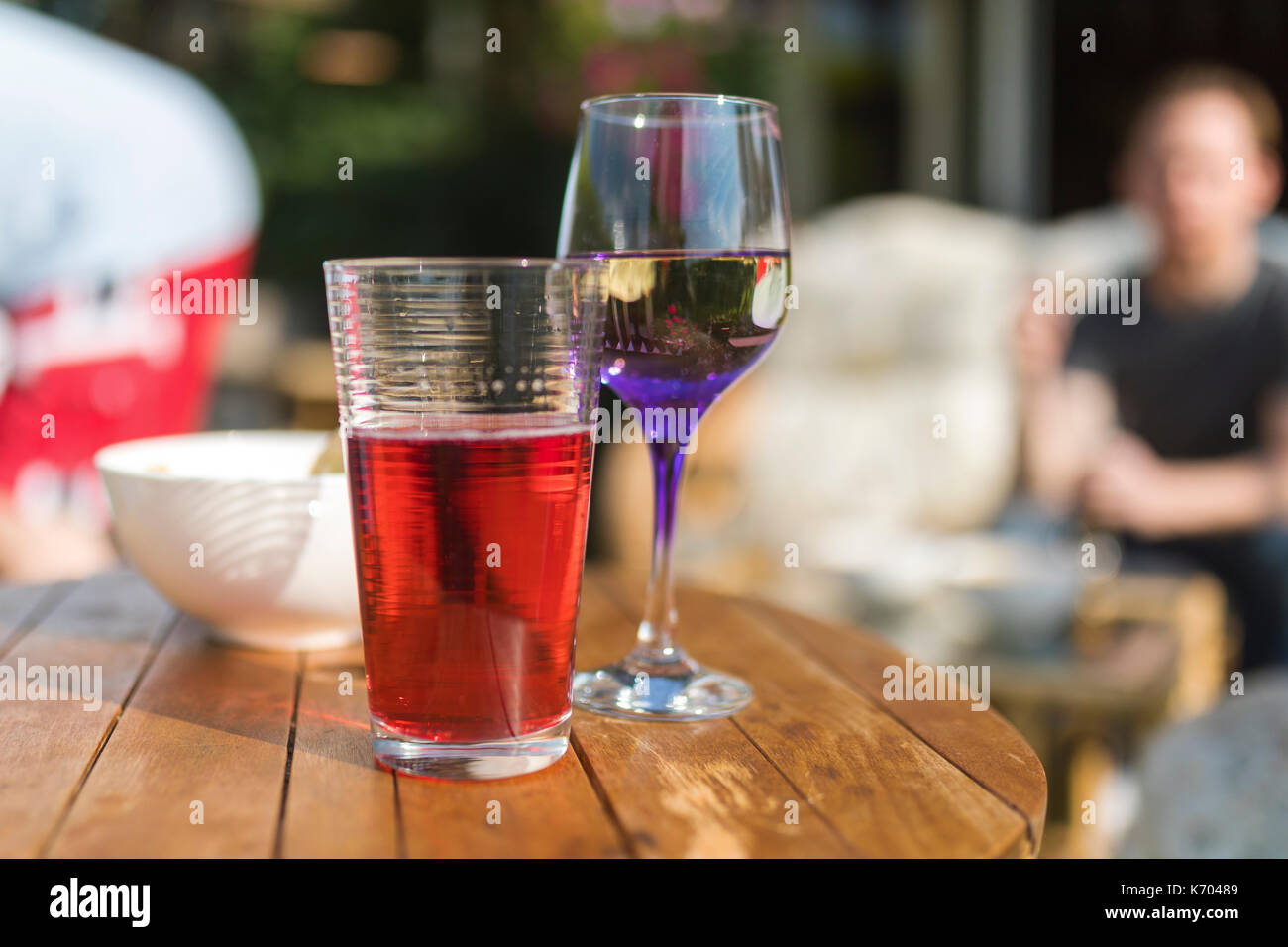 Summer beverages including fruit juice, wine and crisps on a wooden