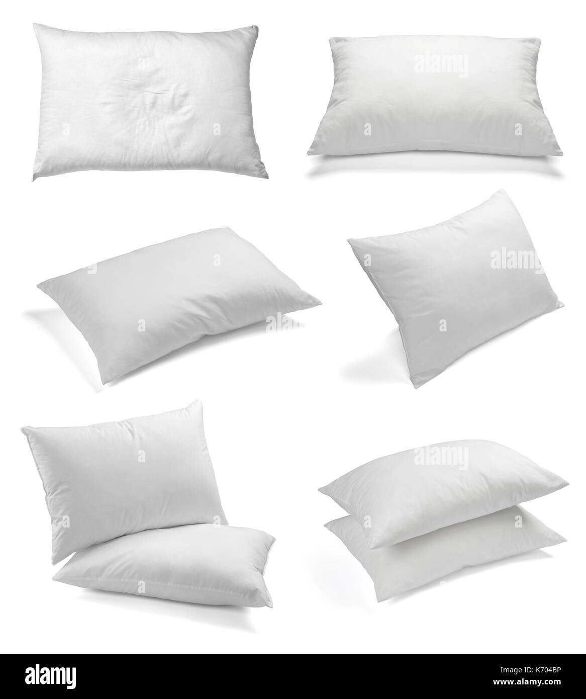 collection of various white pillows on white background. each one is