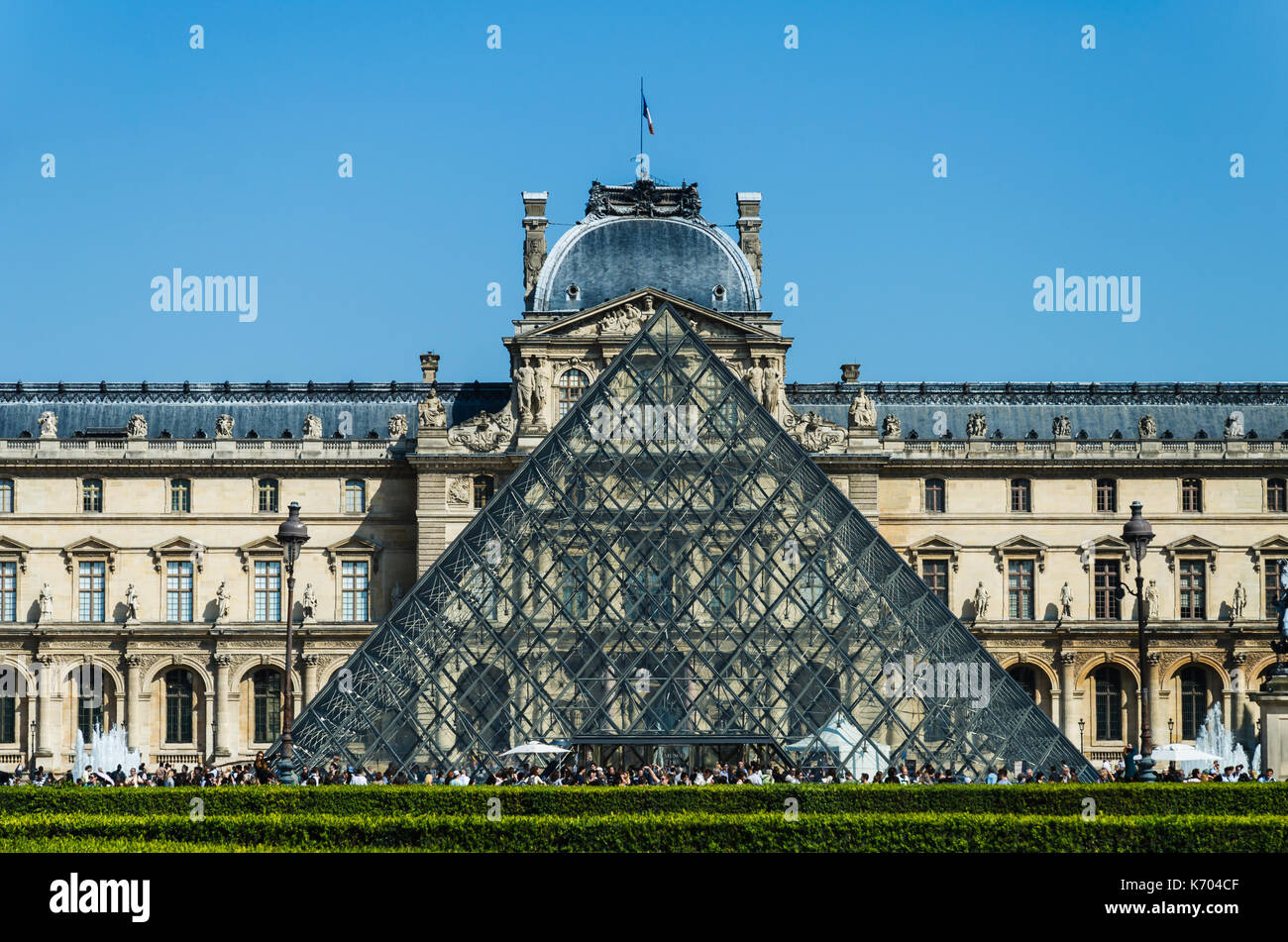 Paris, France - May 17, 2014: Glass pyramid in front of the Louvre Museum in Paris. Stock Photo