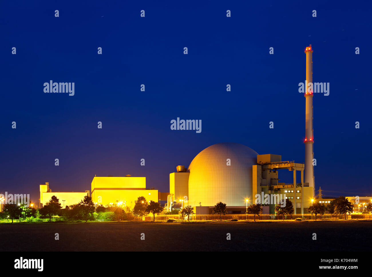 Reactor building of a large nuclear power plant with night blue sky. Stock Photo