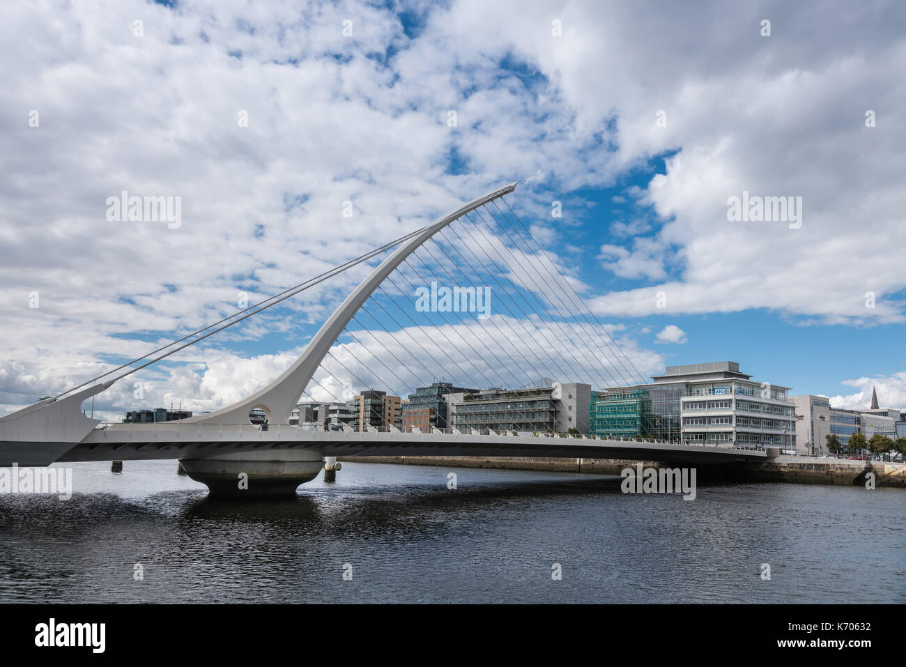 Dublin, Ireland - August 7, 2017: Modern Samuel Beckett bridge under blue-white cloudscape with new office buildings in back. in sky Stock Photo - Alamy