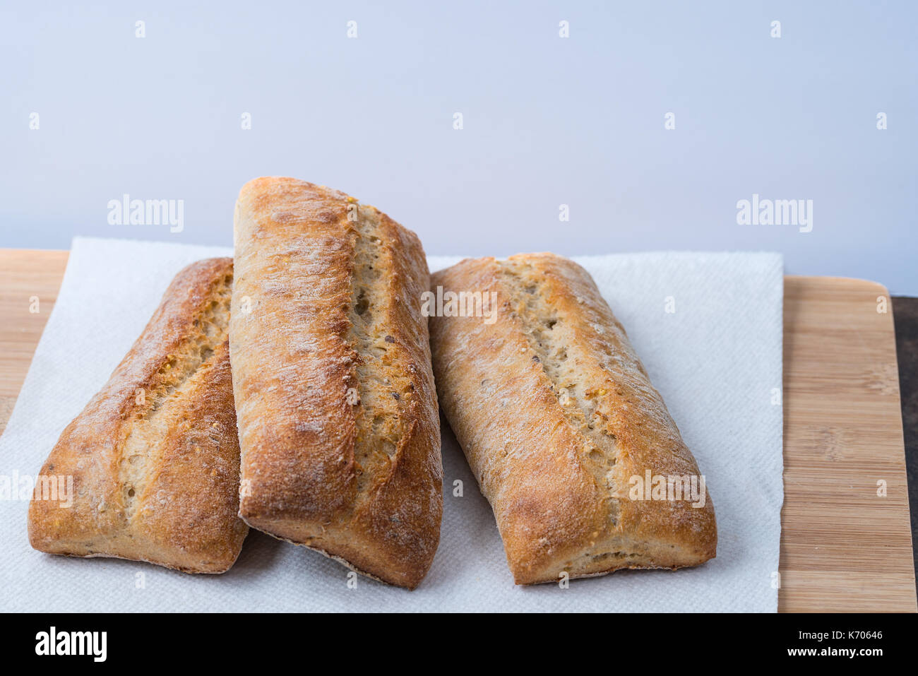 Ciabatta bread on cutting board, three loaves Stock Photo