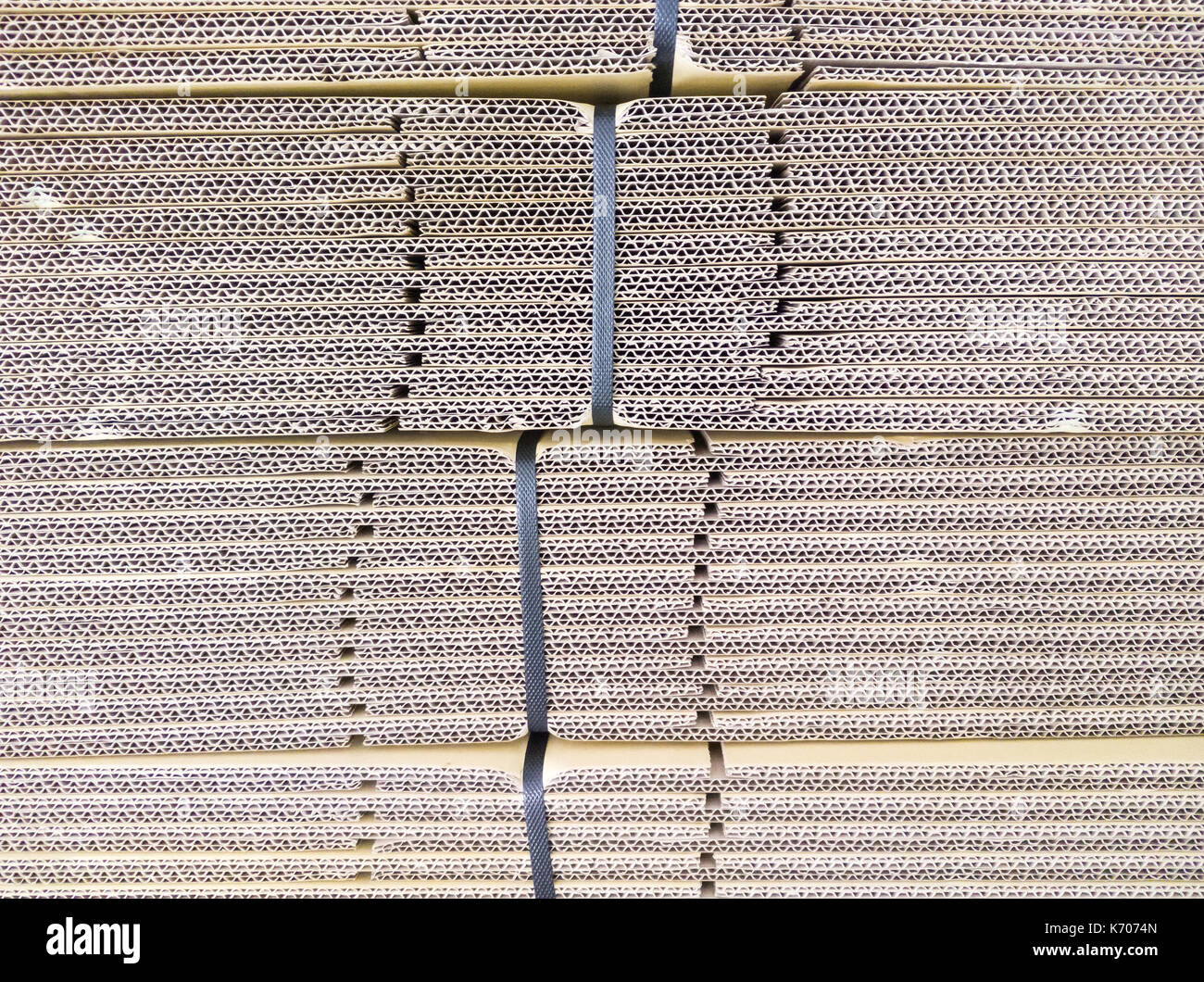 Detail of the cardboard stack with the plastic straps for delivery to
