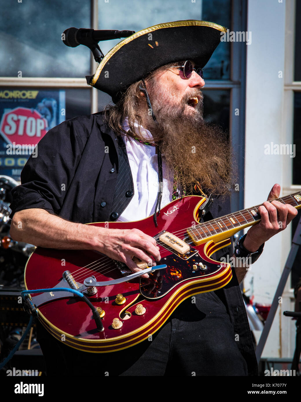 A caucasian male rock guitar performer in a black shirt and pirate hat  sings at a local outdoor music festival in Keene, NH Stock Photo - Alamy