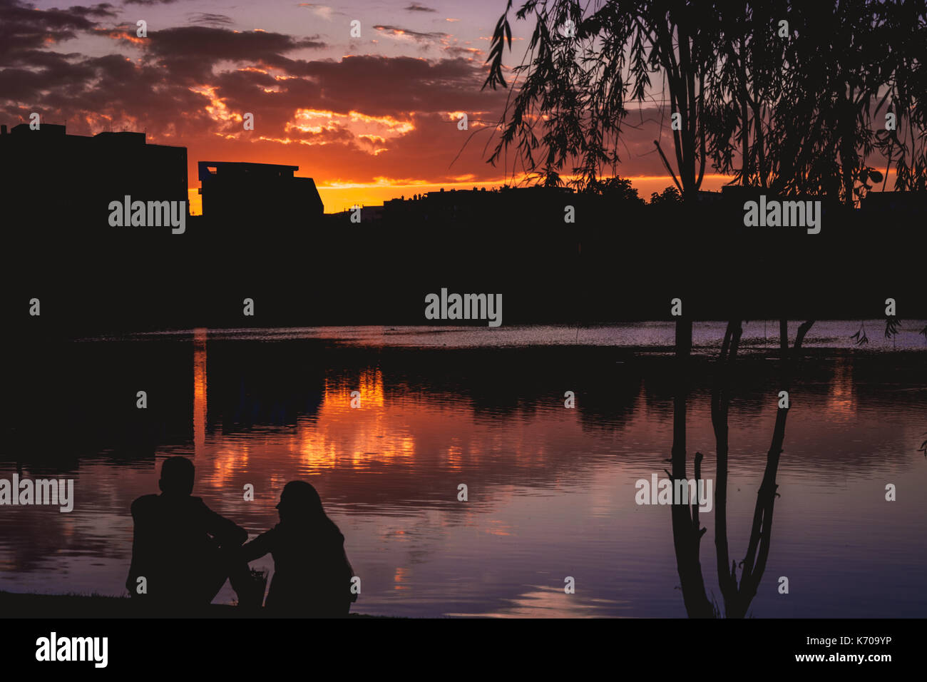 Couple at sunset overlooking lake, Cluj Napoca, Romania Stock Photo