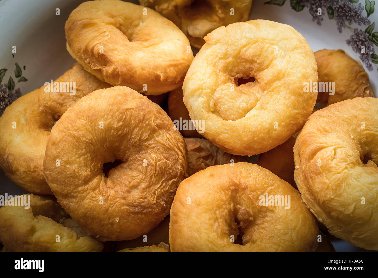 Doughnuts fried in oil lie in the plate closeup Stock Photo Alamy