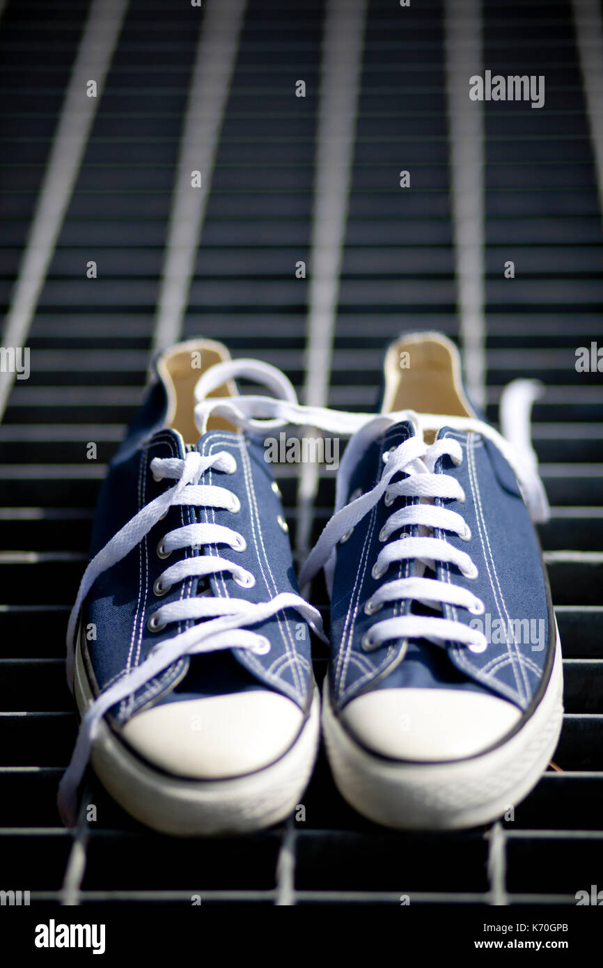 Blue Converse all star sneakers on a grid Stock Photo - Alamy