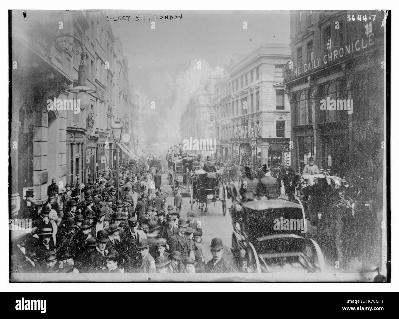 View of Fleet Street in London showing crowds of workers and carriages. Circa 1910. Stock Photo